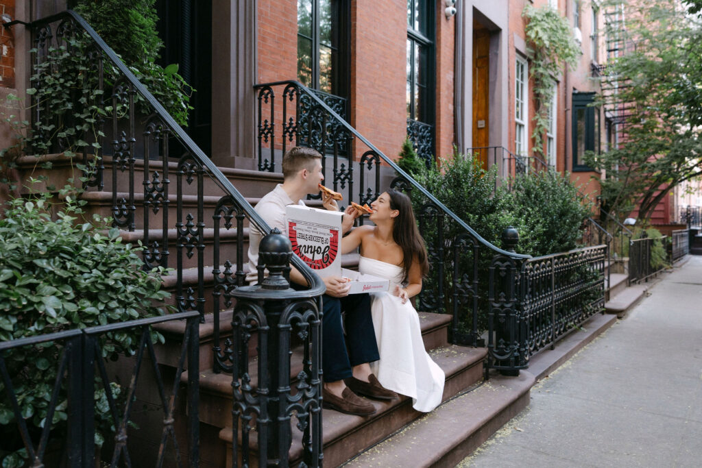 candid engagement photos of a couple laughing on a sidewalk in the west village
