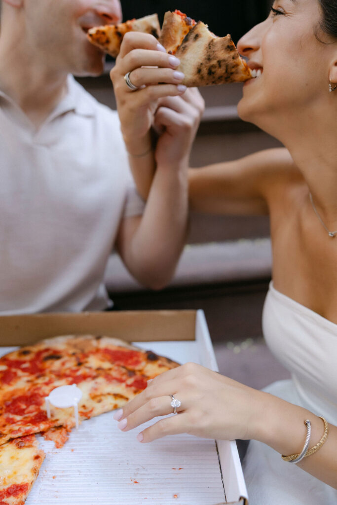 close up engagement photos of a couple sharing pizza during an intimate nyc engagement session