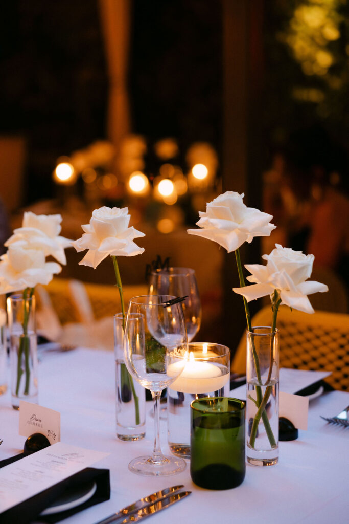 Candlelit wedding reception table with white floral arrangements, glassware, and elegant table settings at an intimate luxury New York City wedding.