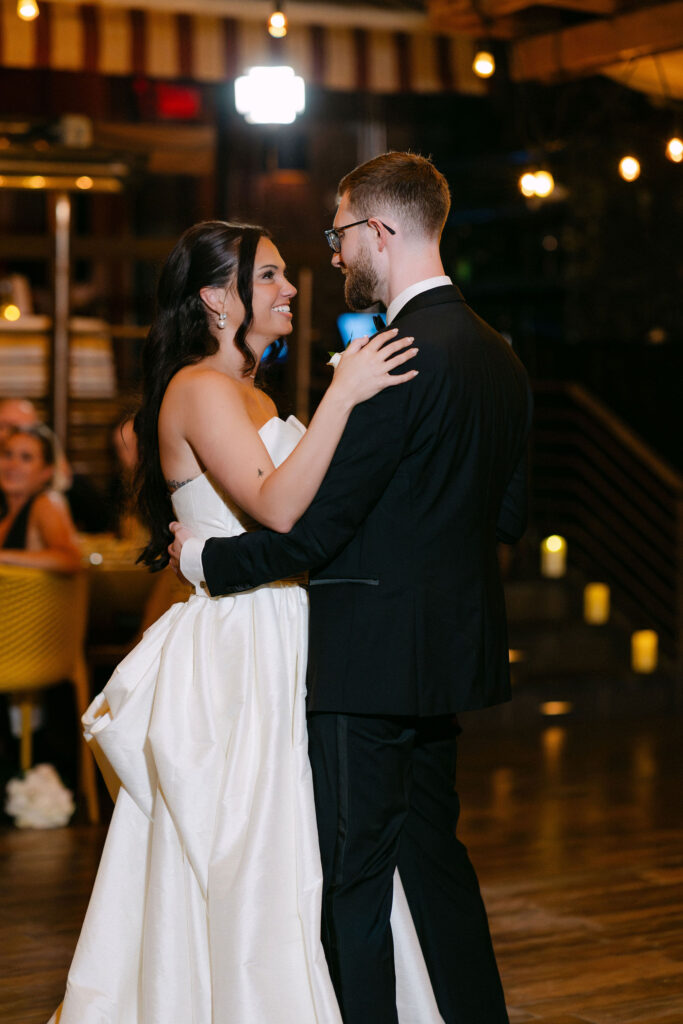 Bride and groom sharing their first dance during a candlelit wedding reception at an intimate luxury New York City wedding.