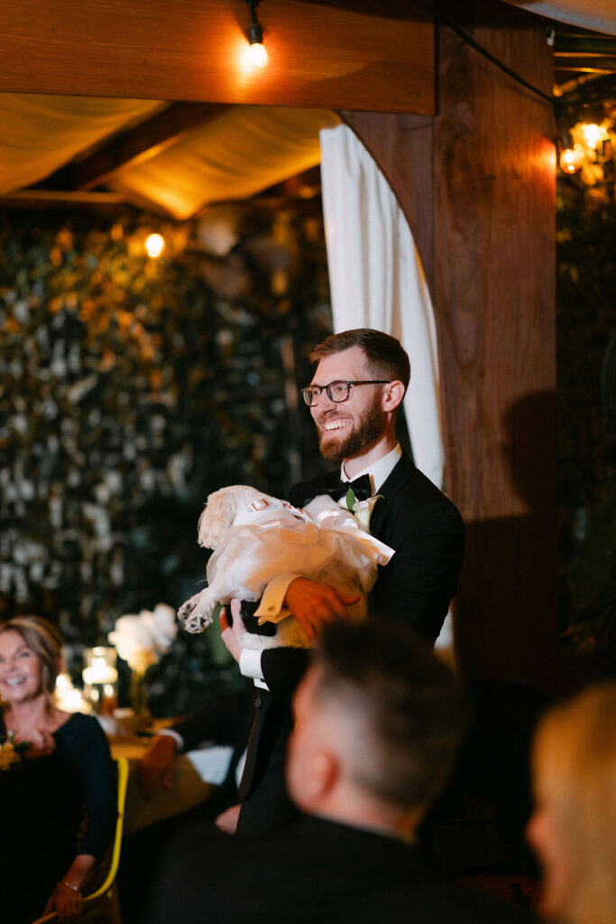 Wedding guest giving a heartfelt speech during an intimate candlelit wedding reception in SoHo, New York City.