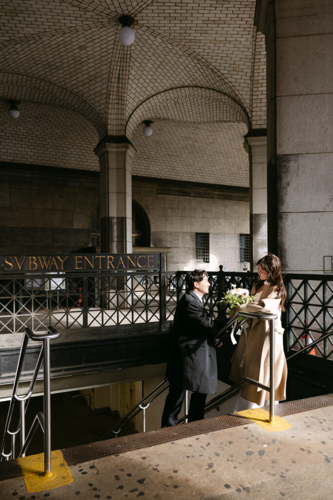 Bride and groom standing together inside a grand arched interior