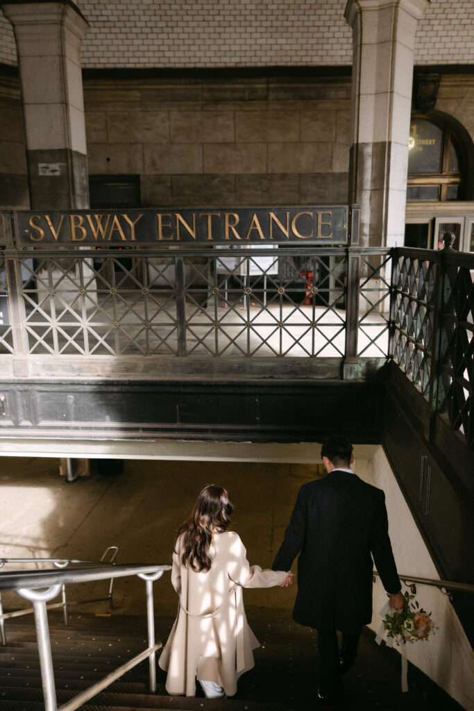 Bride and groom walking together inside a grand interior space