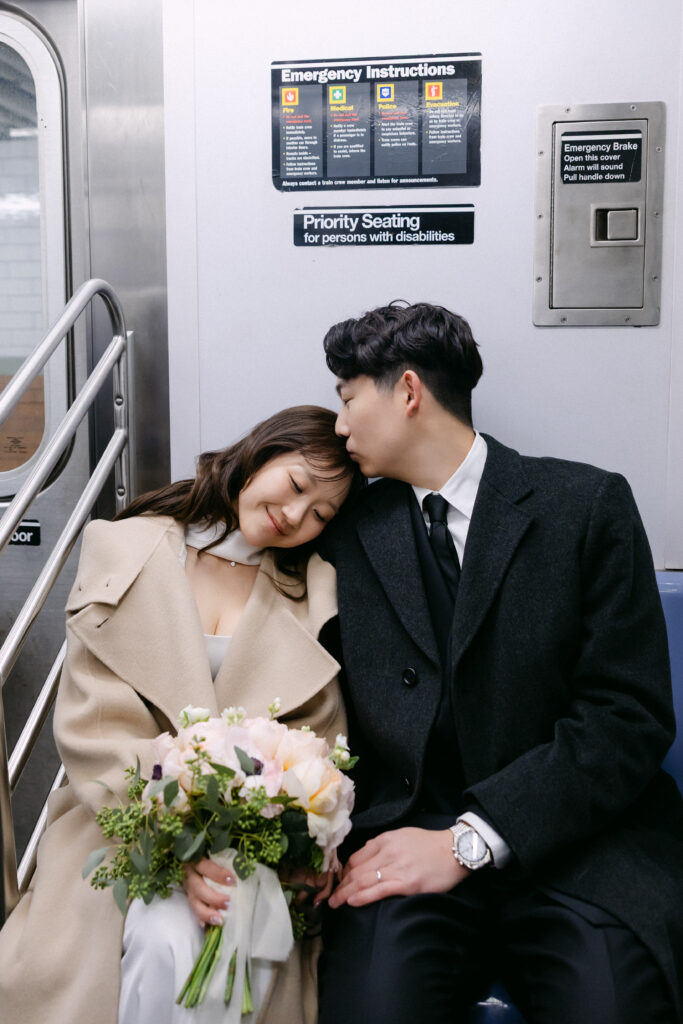 Bride and groom sitting together on a subway train