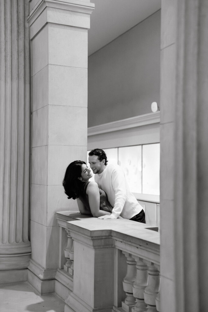 black and white nyc engagement session photo of a couple sharing a quiet moment inside the metropolitan museum of art