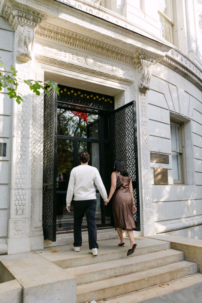 nyc engagement session photo of a couple walking up the steps at the metropolitan museum of art