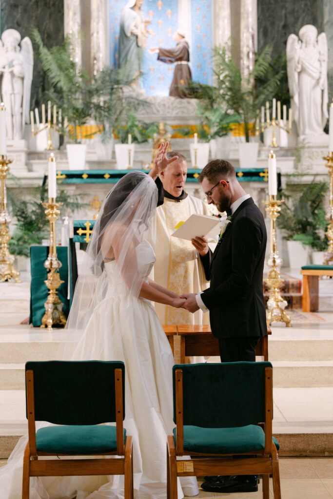 Bride and groom sharing a quiet moment at the altar during their SoHo church wedding ceremony in New York City