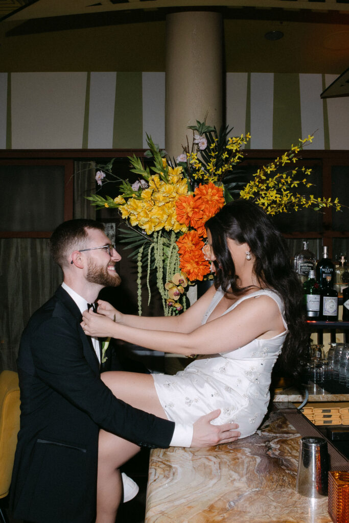 Bride laughing as the groom lifts her during a joyful wedding reception in SoHo, New York City.