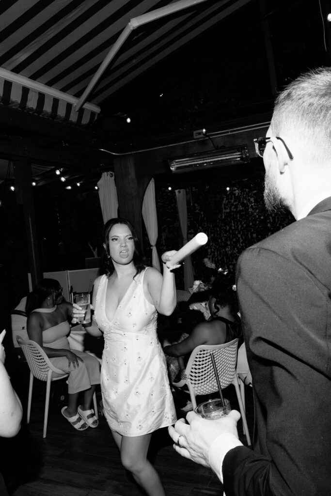 Bride dancing joyfully during a late-night wedding reception in SoHo, New York City, captured in black and white.
