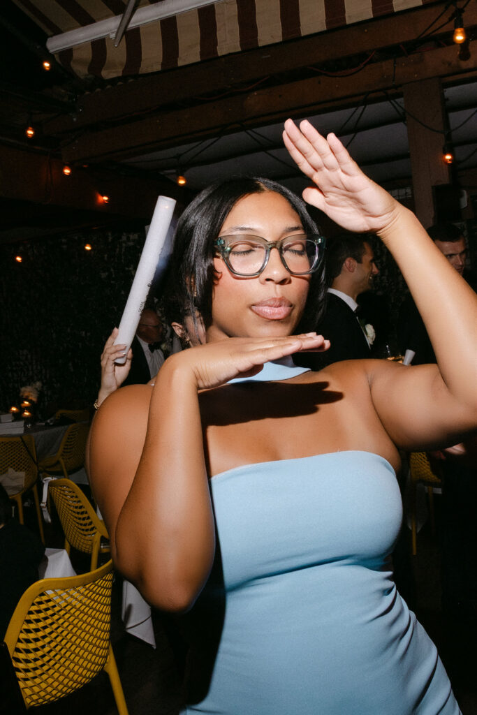 Wedding guest dancing enthusiastically during a lively wedding reception in SoHo, New York City.