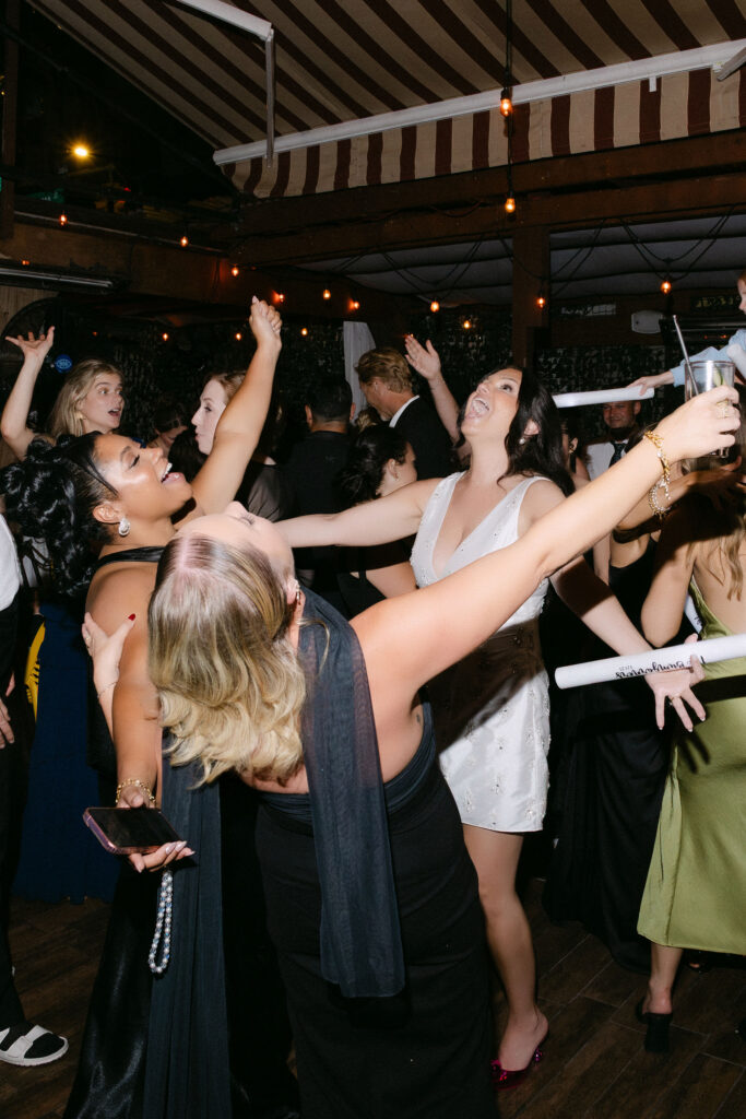 Wedding guests dancing together on the dance floor during a lively late-night wedding reception in SoHo, New York City.