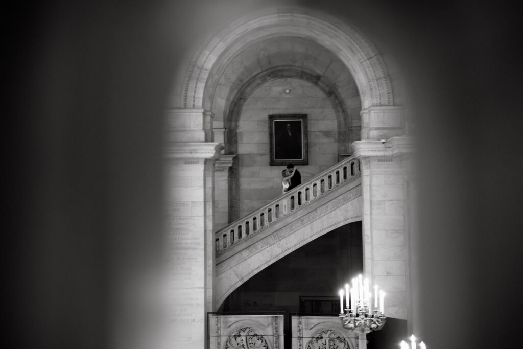Black and white photo of New York Public Library staircase and archway in NYC