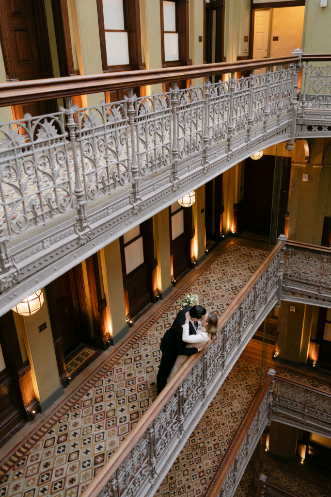 couple on balcony inside beekman hotel nyc wedding photos before city hall