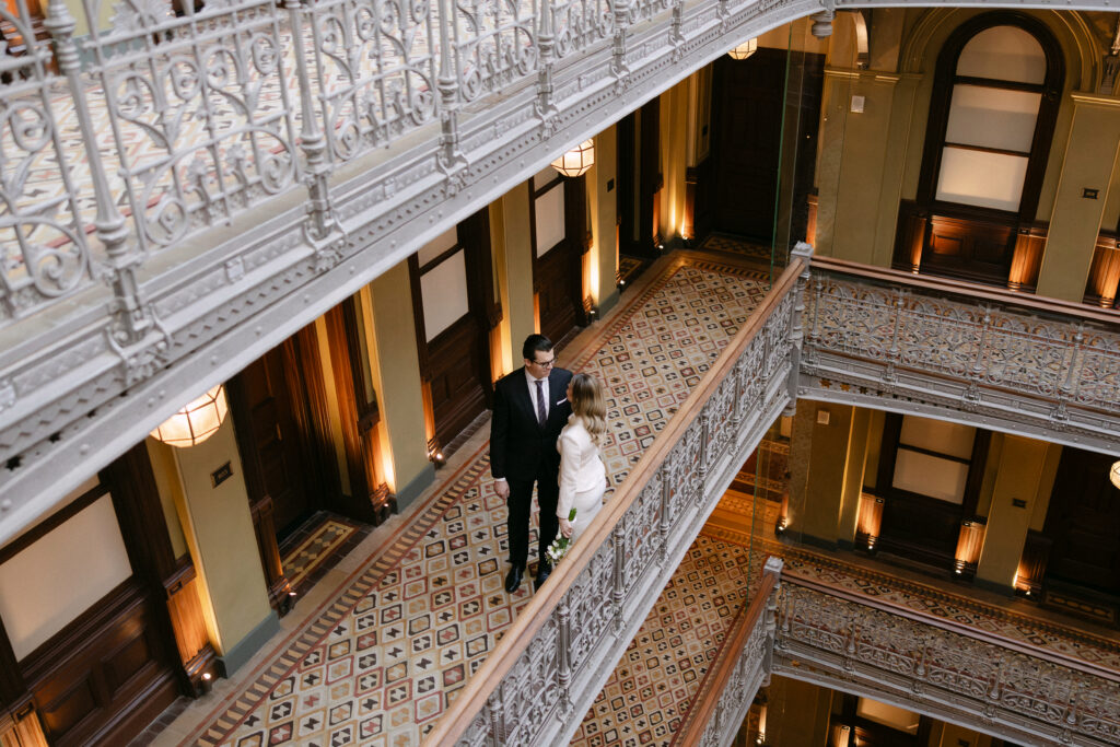 couple walking inside beekman hotel nyc wedding elopement before city hall ceremony