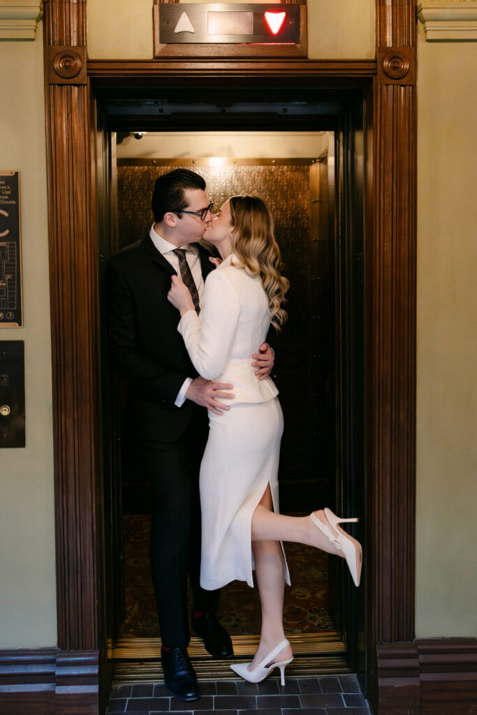 playful couple kissing doorway beekman hotel nyc elopement before city hall wedding