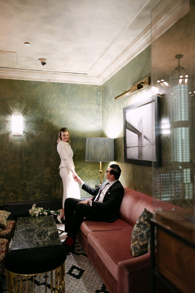 couple relaxing inside beekman hotel nyc elopement before city hall wedding photos