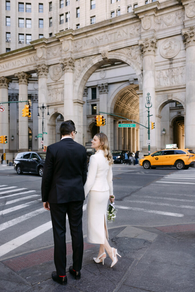 couple walking in nyc street after beekman hotel elopement heading to city hall wedding