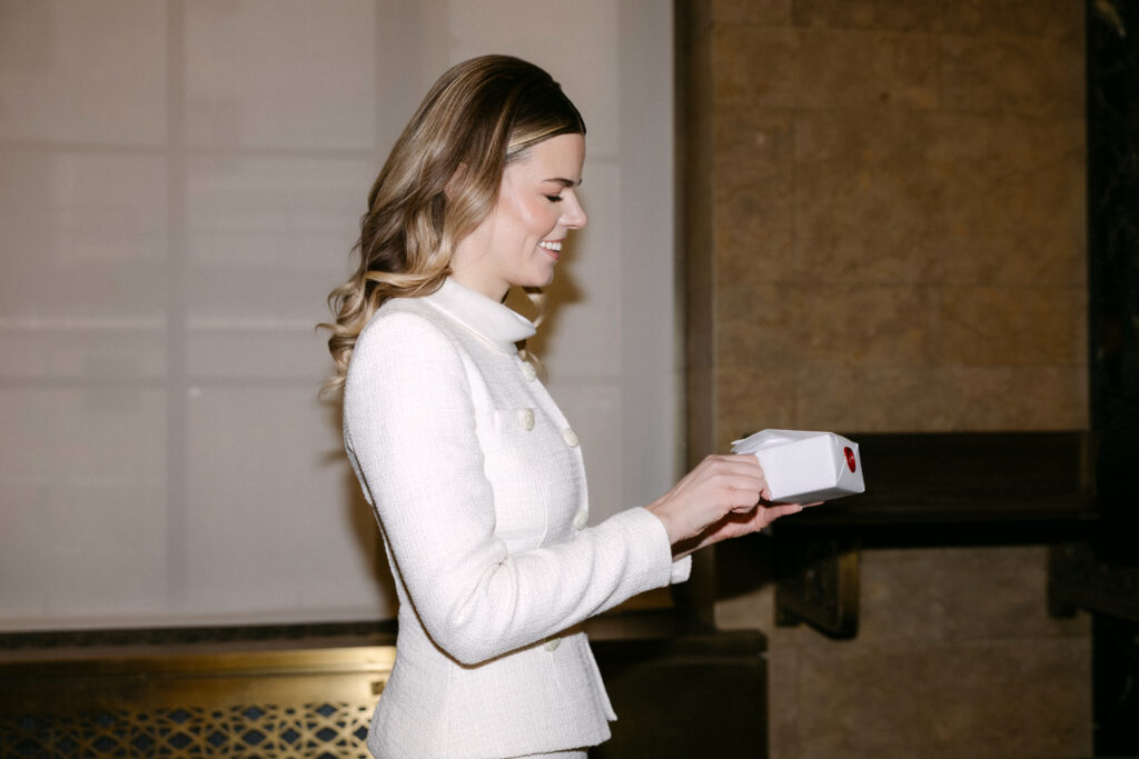 bride holding vows before nyc city hall elopement wedding moment