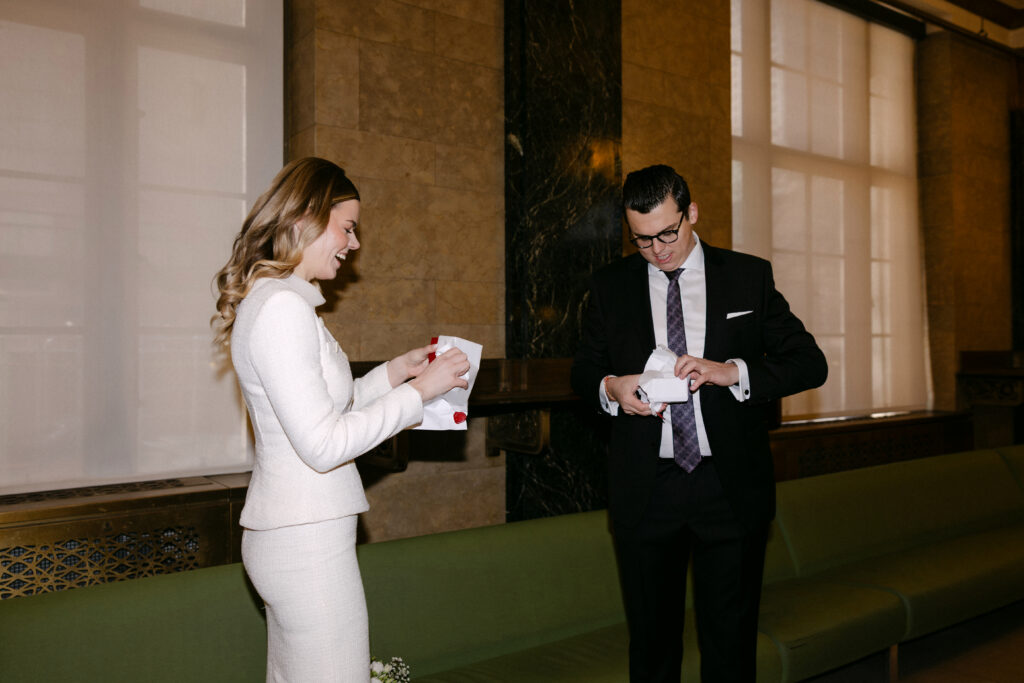 couple reading vows before nyc city hall elopement wedding quiet moment