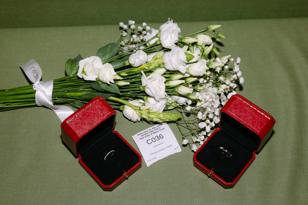 wedding rings in red boxes with flowers nyc city hall elopement detail