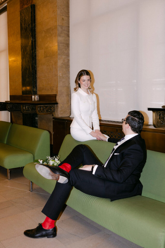 couple relaxing while waiting for nyc city hall wedding elopement candid moment
