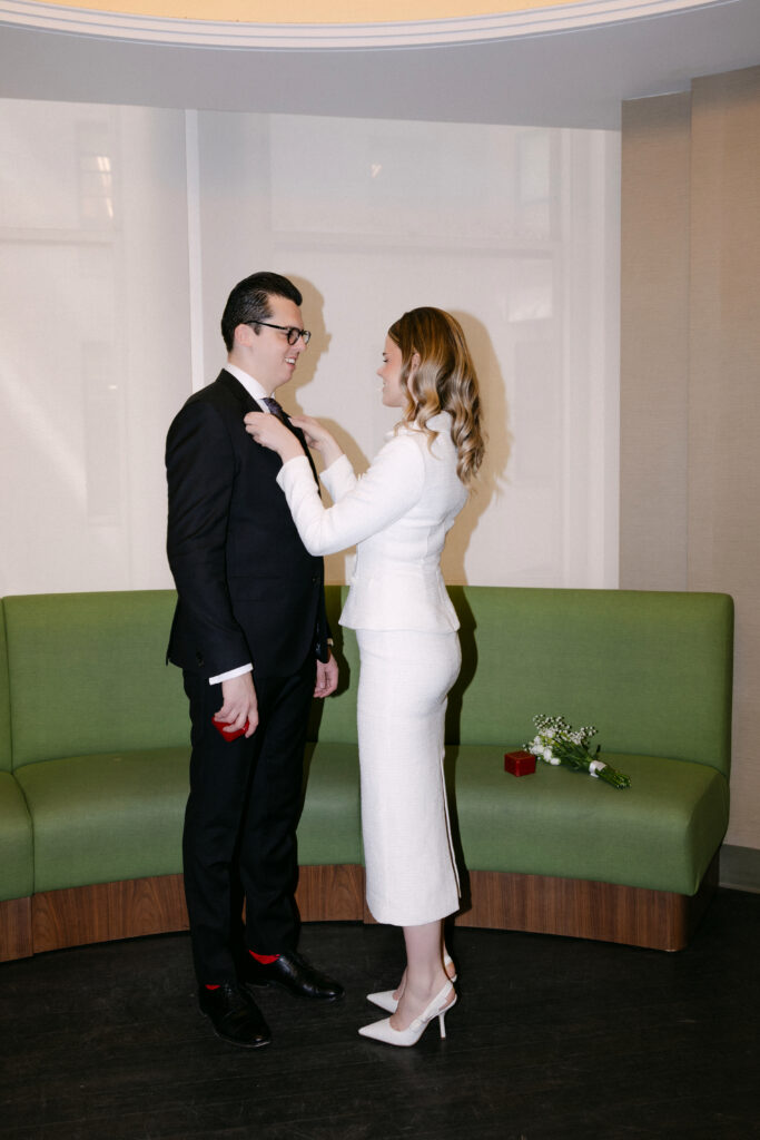 couple helping each other before nyc city hall wedding elopement candid moment
