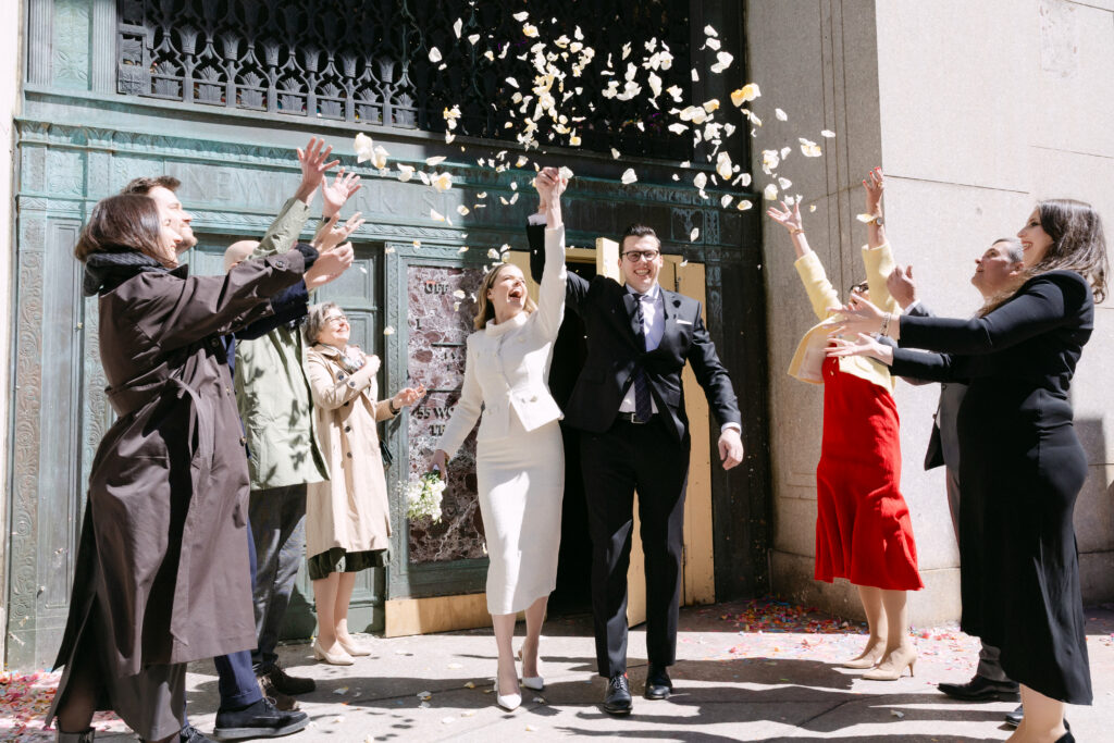 nyc city hall wedding confetti celebration just married couple exit elopement