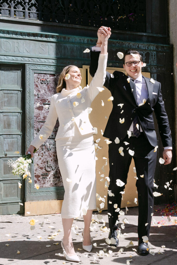 just married couple walking with confetti nyc city hall wedding elopement exit