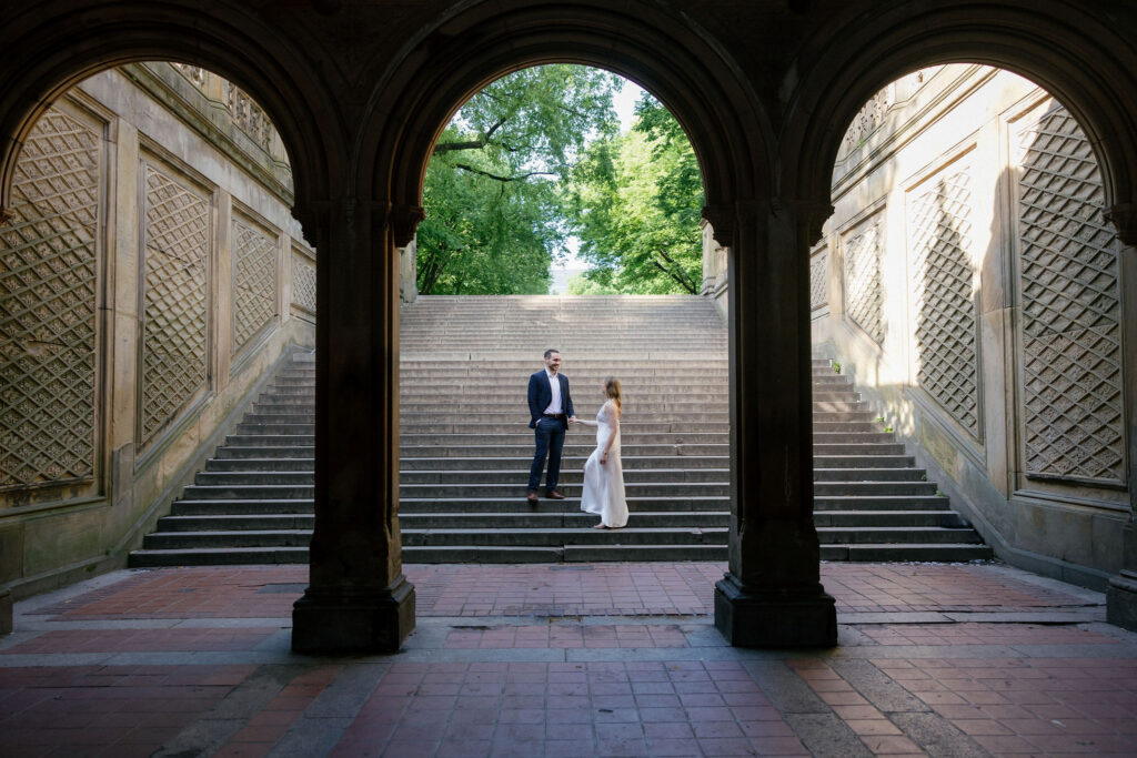 Bride-to-be posing beside the ornate tilework at Bethesda Terrace during a Central Park engagement session.