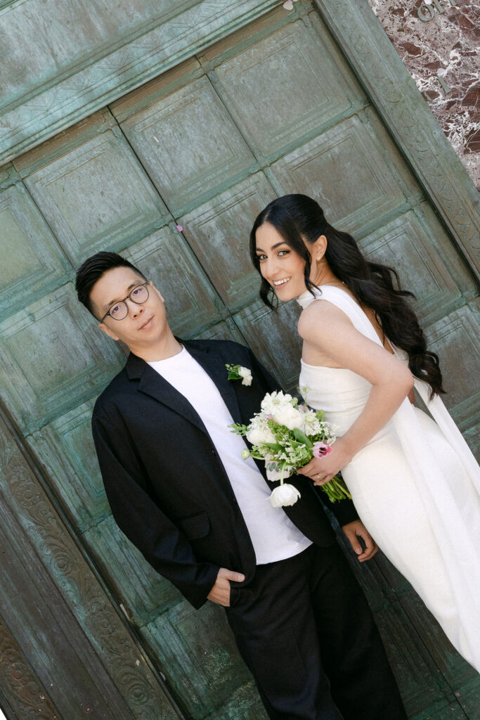 Newlyweds kissing outside the Manhattan Marriage Bureau after their City Hall wedding ceremony.