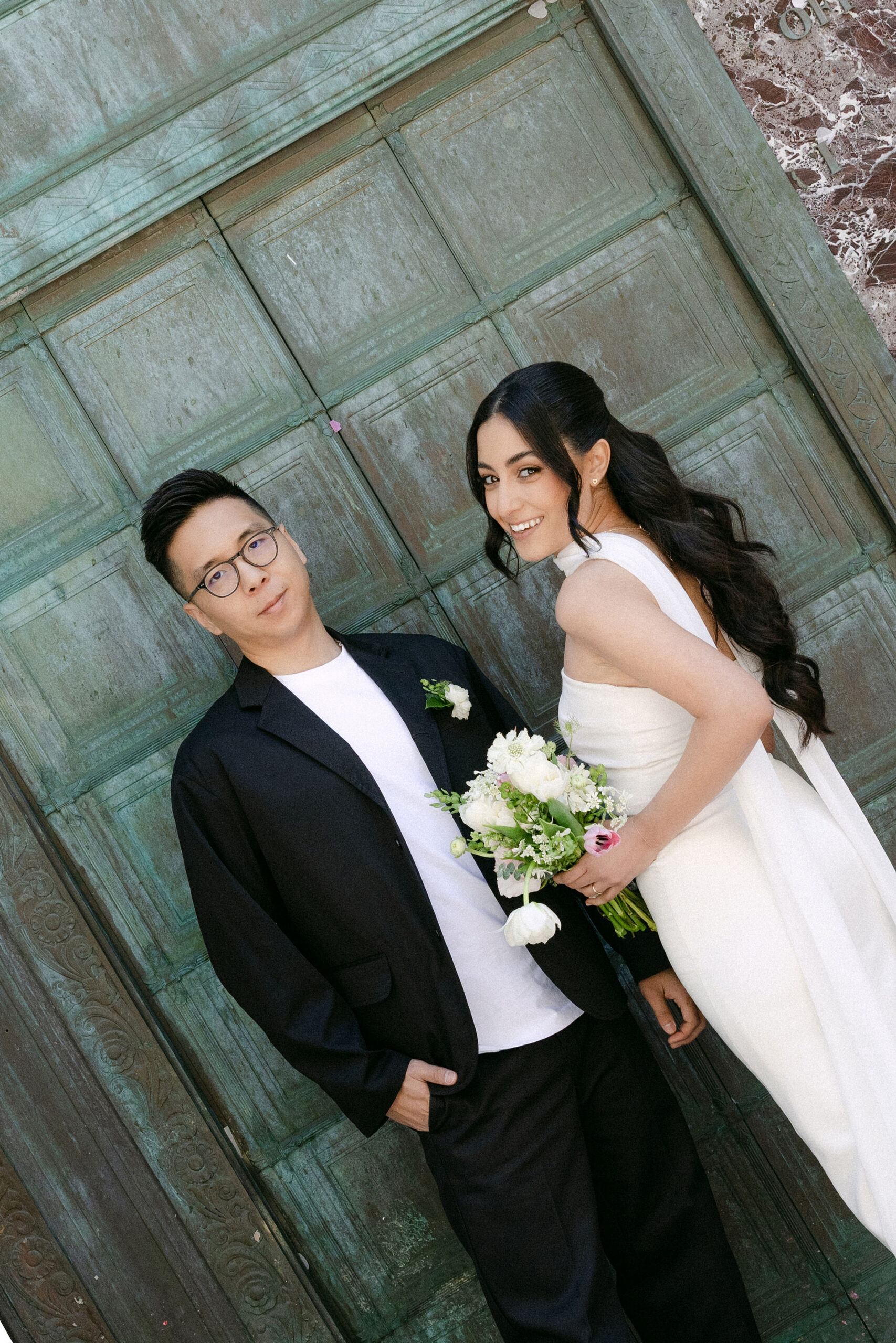 Newlyweds kissing outside the Manhattan Marriage Bureau after their City Hall wedding ceremony.