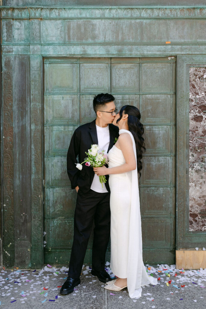 Editorial portrait of newlyweds outside the Manhattan Marriage Bureau after their City Hall wedding.