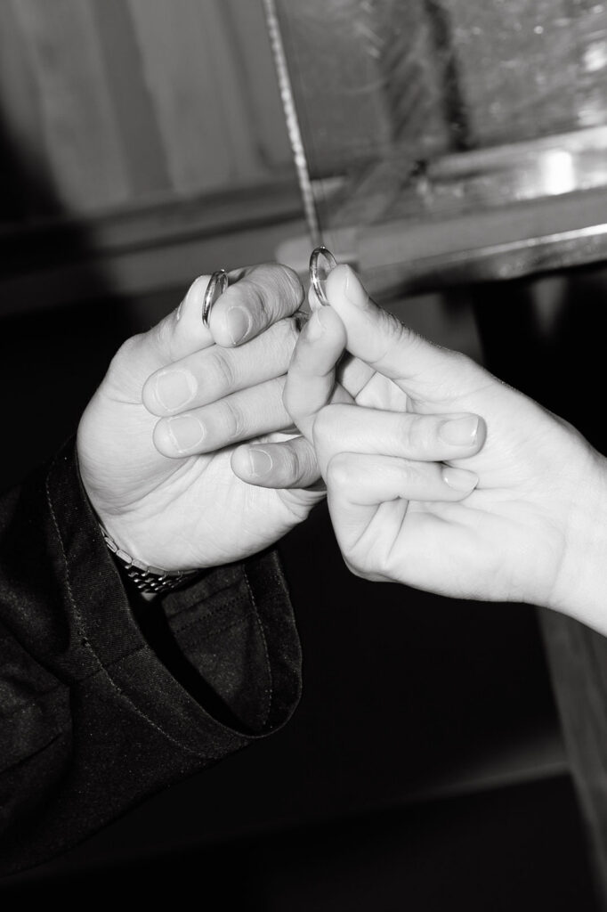 Close-up of the bride and groom exchanging wedding rings during their Manhattan City Hall ceremony.
